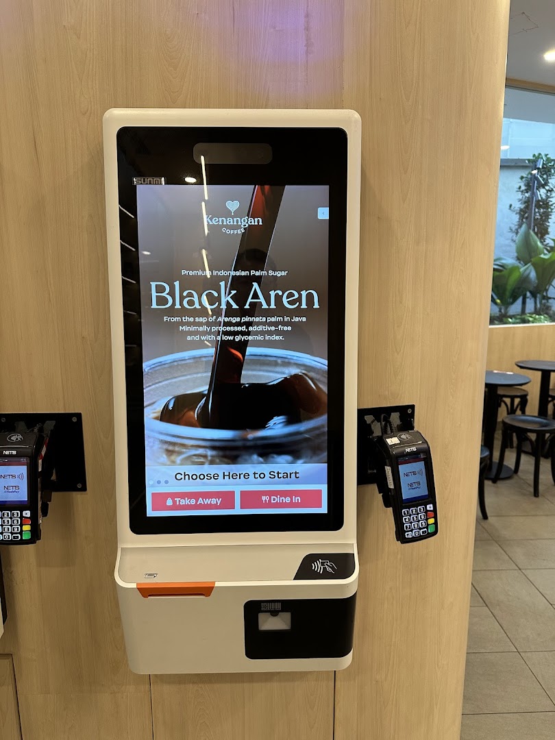 A self-service kiosk at Kenangan Coffee featuring their Black Aren palm sugar drink.