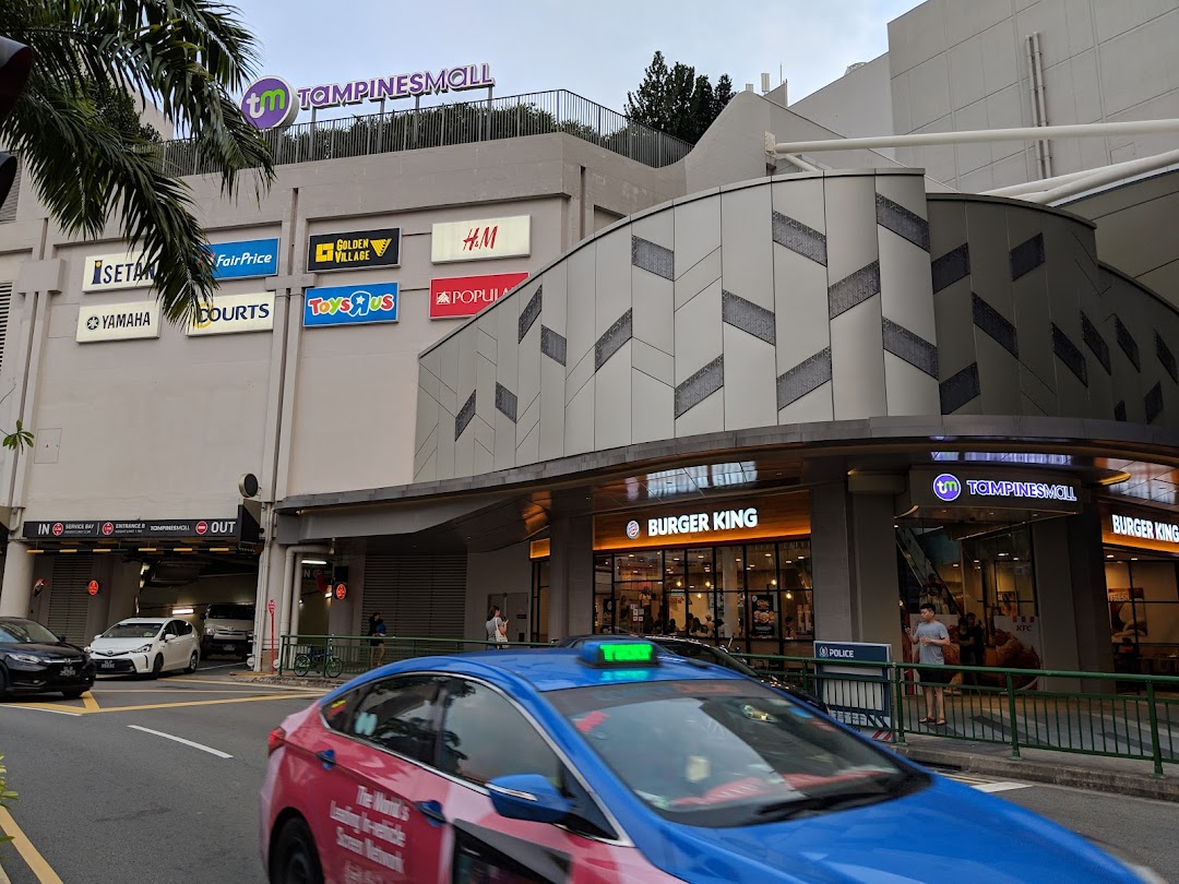 Exterior view of Tampines Mall, featuring Burger King and a glimpse of KFC, alongside other prominent retail signs.
