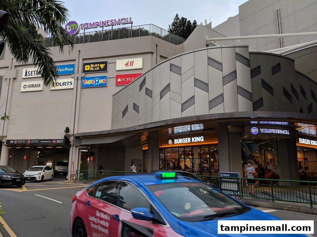 Exterior view of Tampines Mall, featuring Burger King and a glimpse of KFC, alongside other prominent retail signs.