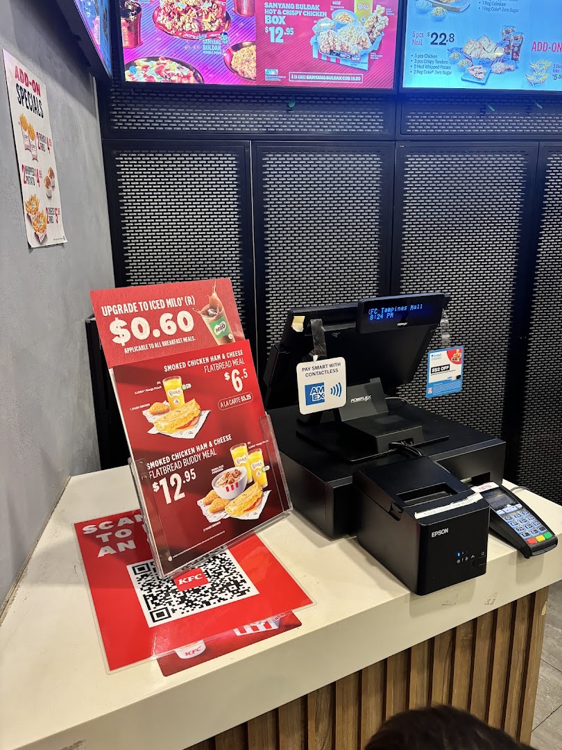 KFC ordering counter showcasing digital menu boards and promotional offers.