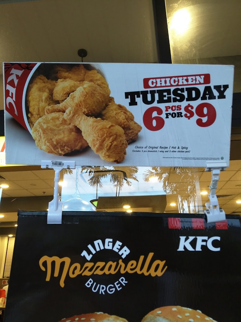Two promotional signs for KFC, featuring a chicken deal and a Zinger Mozzarella Burger.