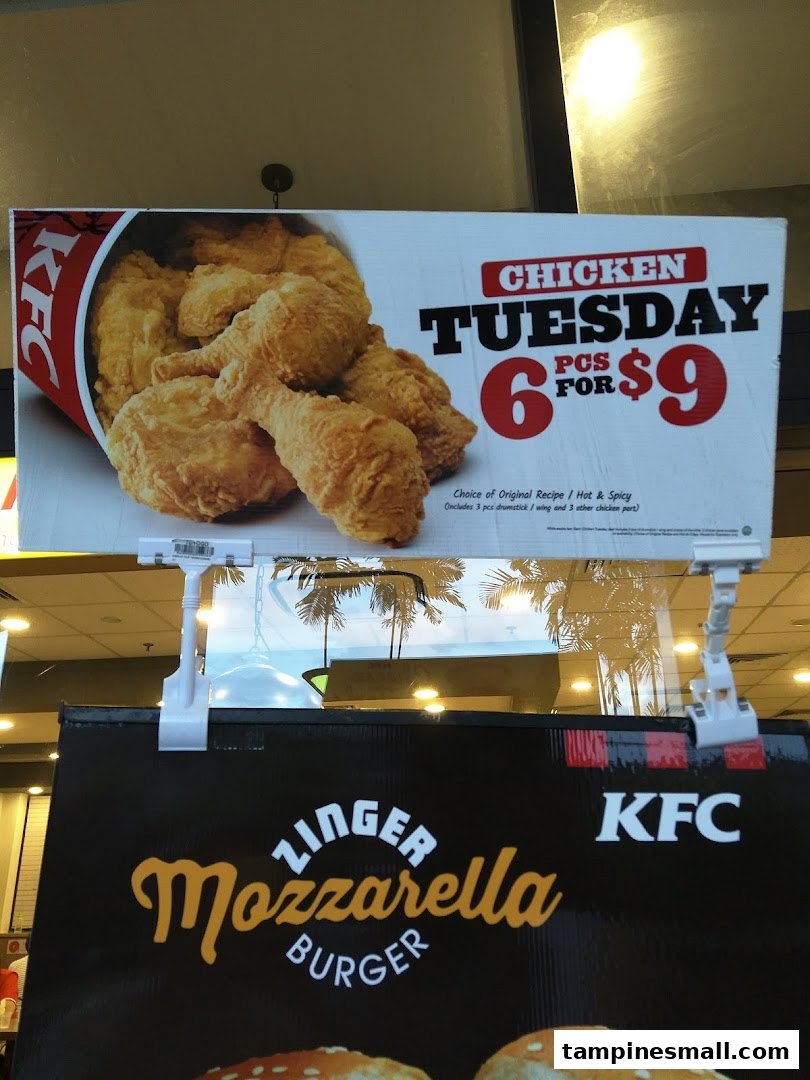 Two promotional signs for KFC, featuring a chicken deal and a Zinger Mozzarella Burger.