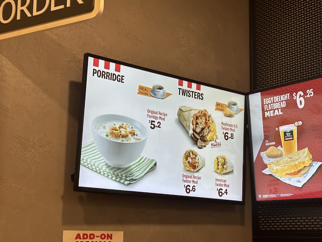 KFC menu board displaying breakfast items like porridge, twisters, and flatbread meals.