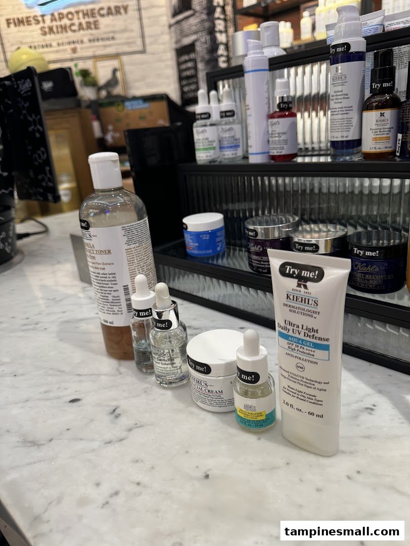 Kiehl's skincare products displayed on a marble counter, featuring toners, serums, and sunscreens.