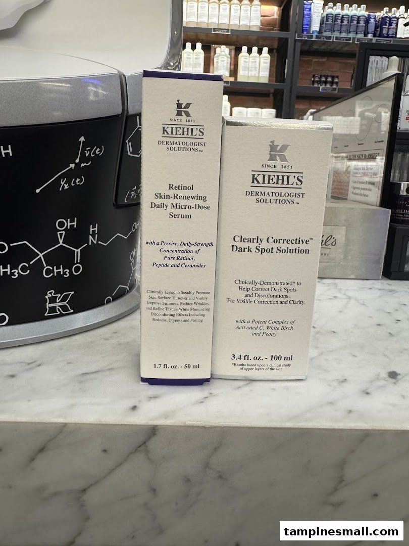 Two Kiehl's skincare product boxes, Retinol Serum and Dark Spot Solution, displayed on a counter.