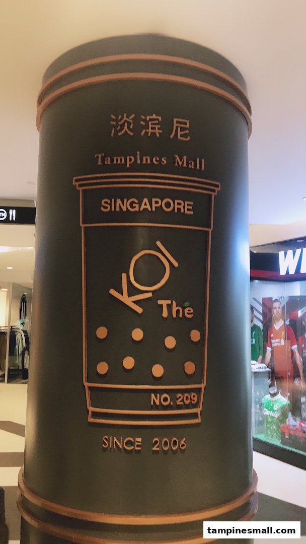 A decorative pillar featuring the KOI Thé logo, Tampines Mall name, and 'Since 2006' text.