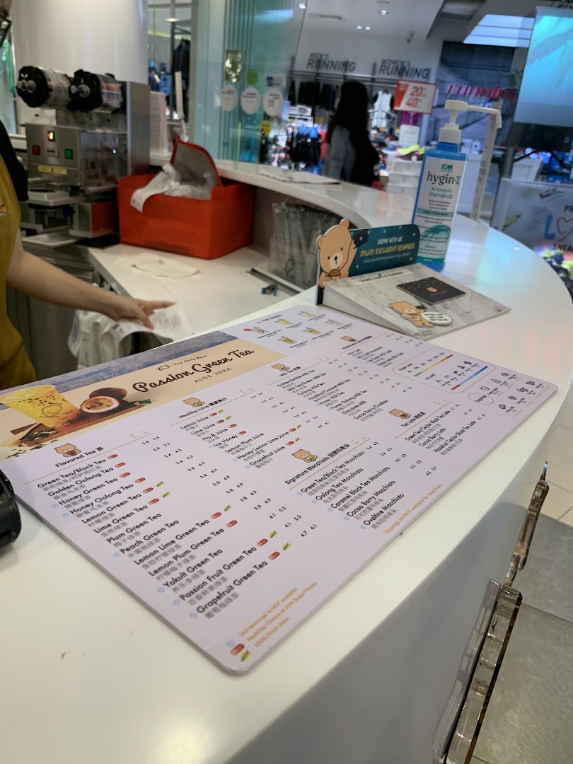 A close-up view of the KOI Thé menu on a white counter, showcasing various bubble tea options.