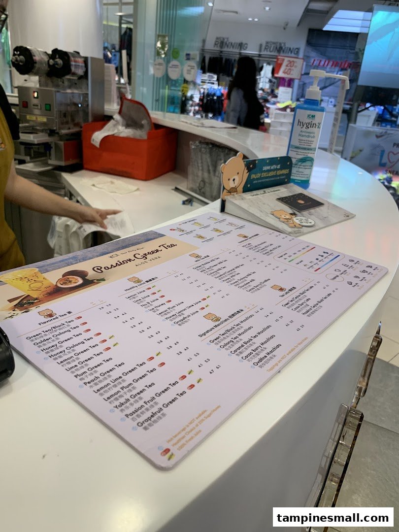 A close-up view of the KOI Thé menu on a white counter, showcasing various bubble tea options.