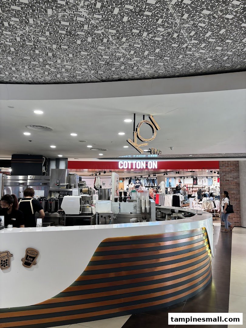 View of KOI Thé's bustling counter with staff preparing refreshing bubble tea drinks.