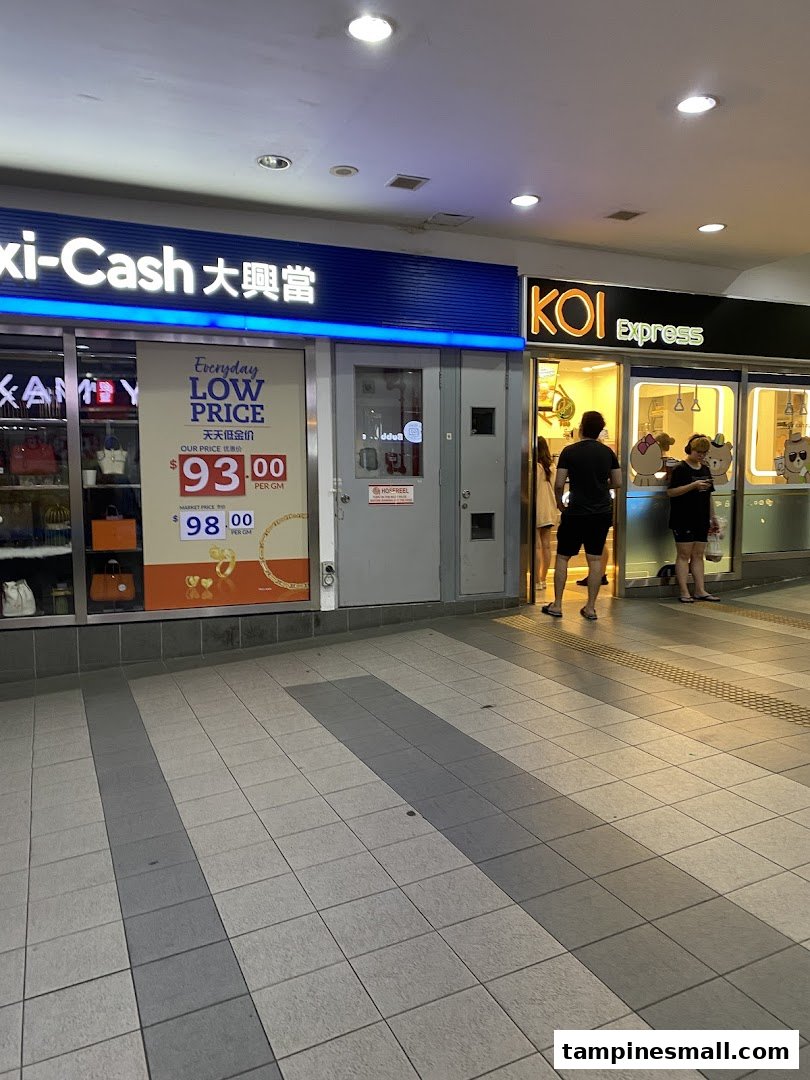 The storefronts of KOI Express and Maxi-Cash at Tampines Mall, with people entering KOI.