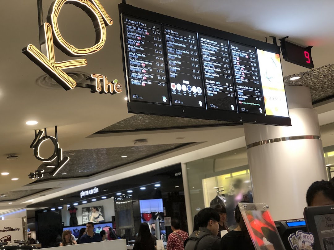 Digital menu boards at KOI Thé displaying a wide range of bubble tea and beverage options with prices.