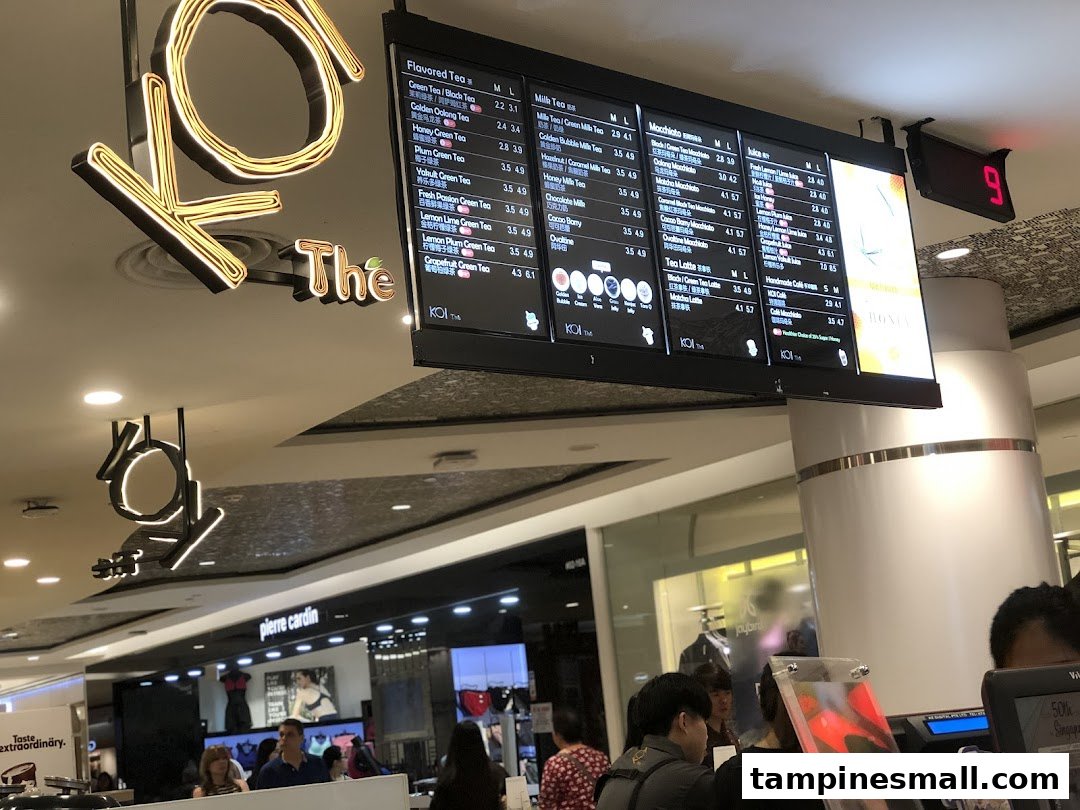 Digital menu boards at KOI Thé displaying a wide range of bubble tea and beverage options with prices.