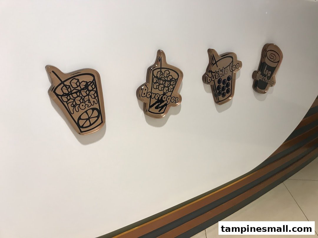 Decorative icons on a wall showcasing various drink types offered by KOI Thé.