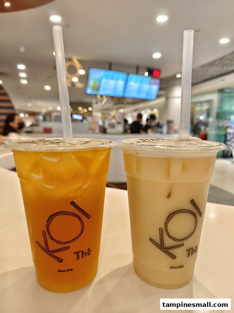 Two refreshing KOI Thé beverages, one fruit tea and one milk tea, ready to enjoy.
