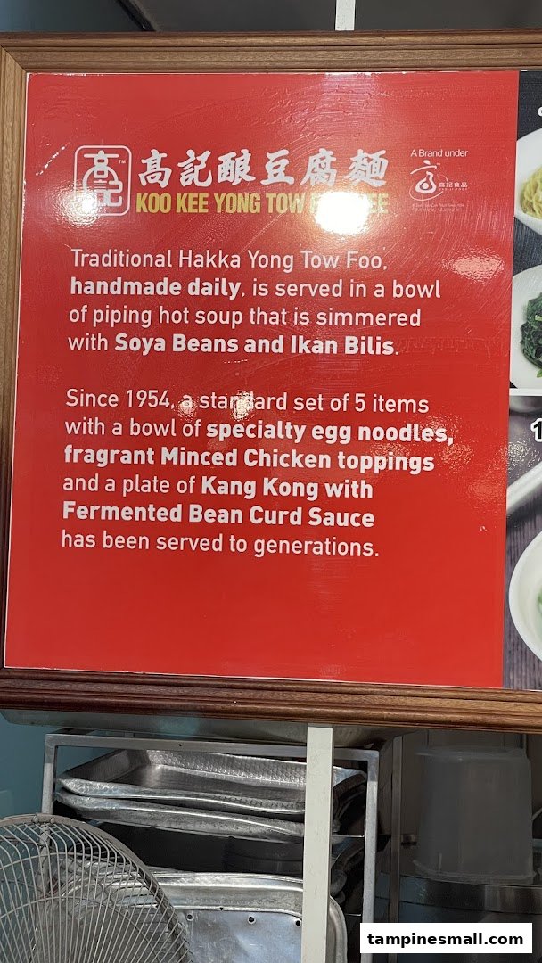 A red sign detailing the history and specialty of Koo Kee Yong Tow Foo Mee's traditional Hakka Yong Tow Foo.