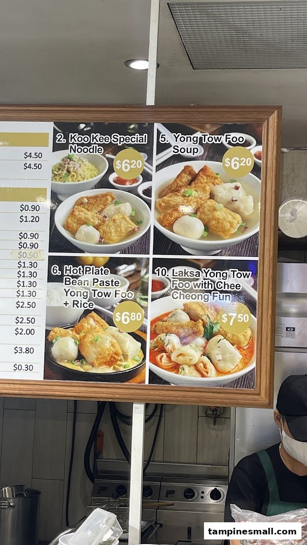 A vibrant menu board displaying various Yong Tow Foo dishes with prices and images.