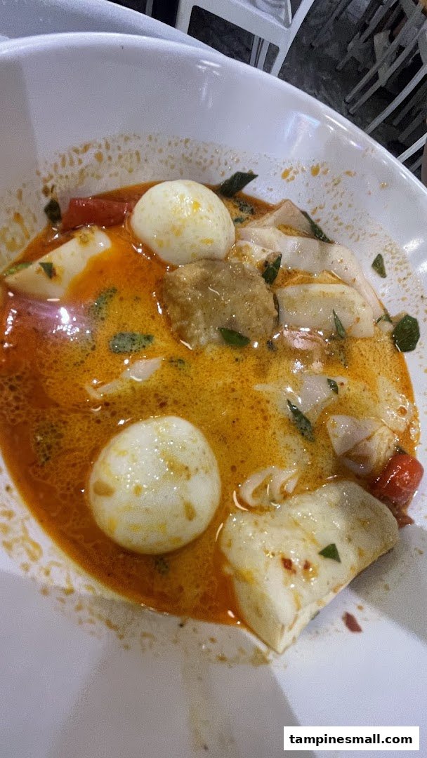A vibrant bowl of spicy Yong Tow Foo Mee with fish paste, tofu, and quail eggs.
