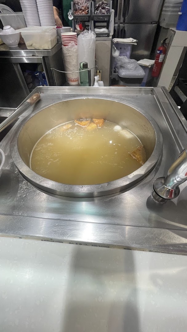 A large pot of simmering broth with ingredients, ready for serving.