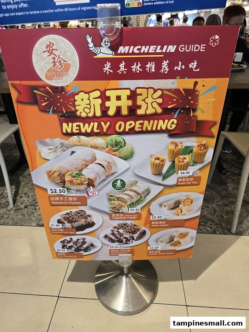 A standee displaying the menu and promotional items for Ann Chin, a Michelin Guide-recommended food stall.