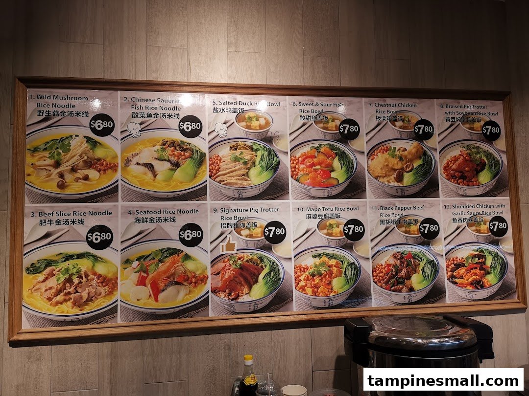 A menu board displaying various rice noodle and rice bowl dishes with prices and images at Kopitiam.