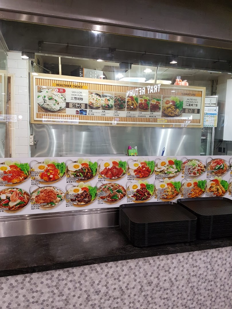 A vibrant display board showcasing various Asian dishes with prices at a Kopitiam food stall.
