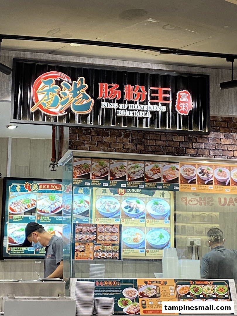 A food stall counter displaying menu boards with various Hong Kong-style rice rolls, congee, and side dishes.