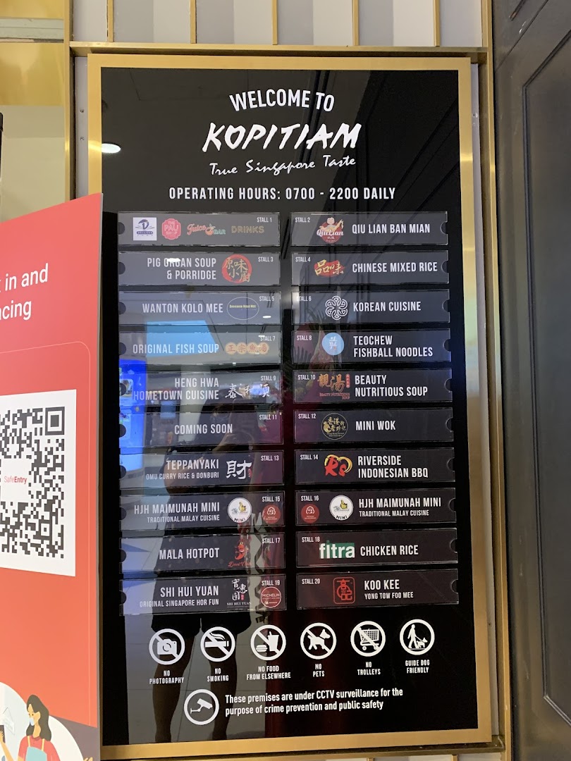 A directory board for Kopitiam, showcasing various food stalls and operating hours within the food court.