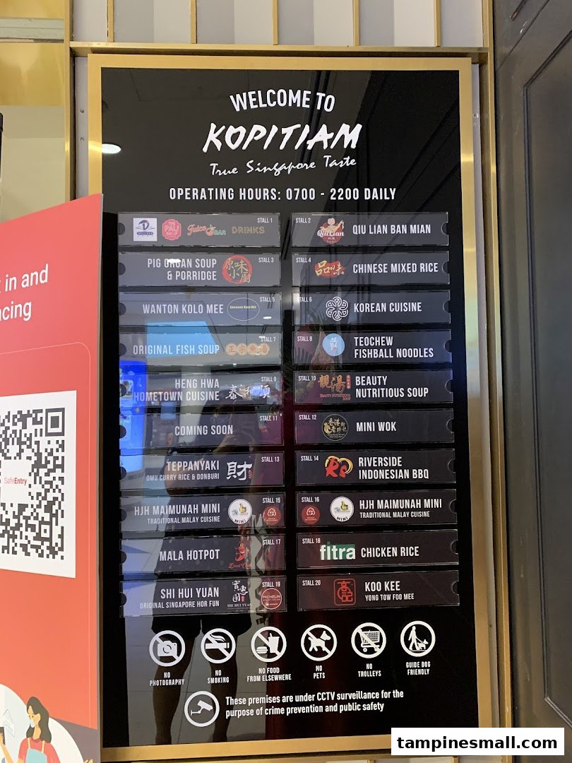 A directory board for Kopitiam, showcasing various food stalls and operating hours within the food court.