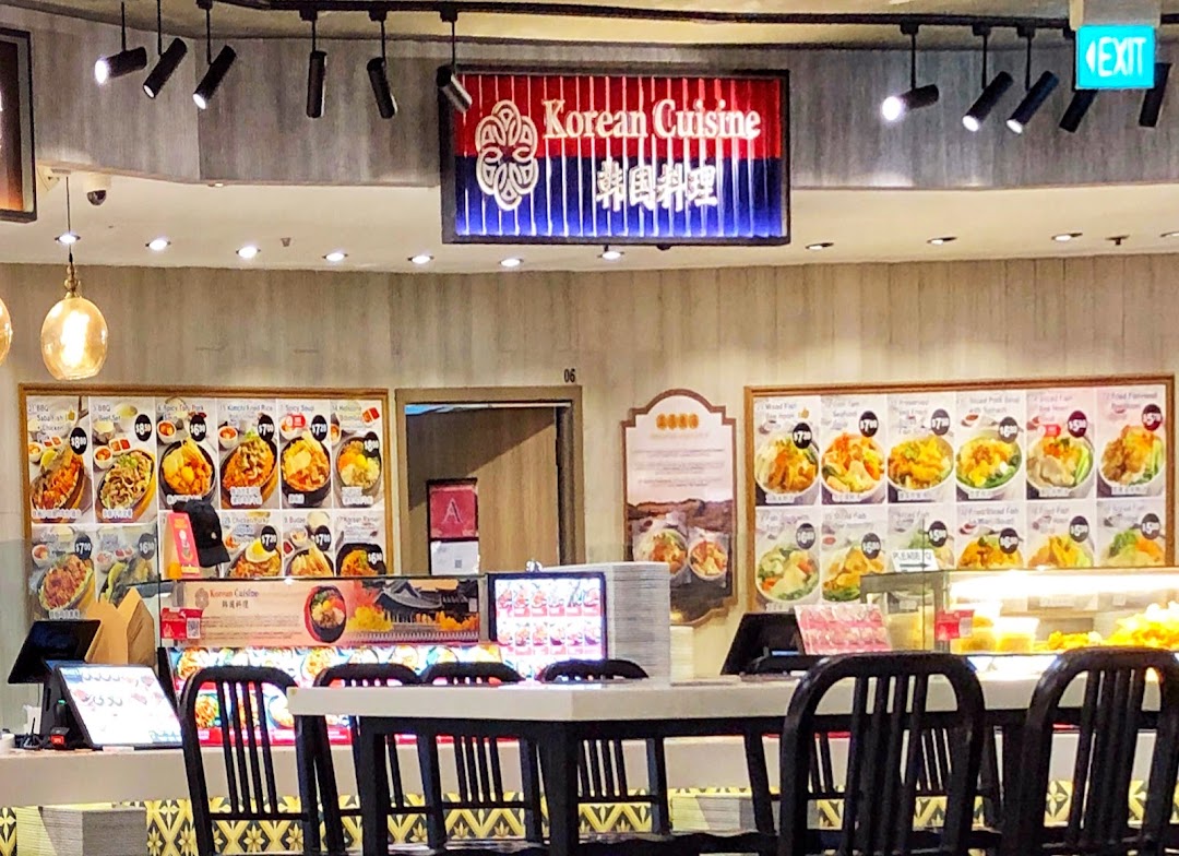 An interior view of a 'Korean Cuisine' food stall within a Kopitiam food court, featuring menu displays and dining area.
