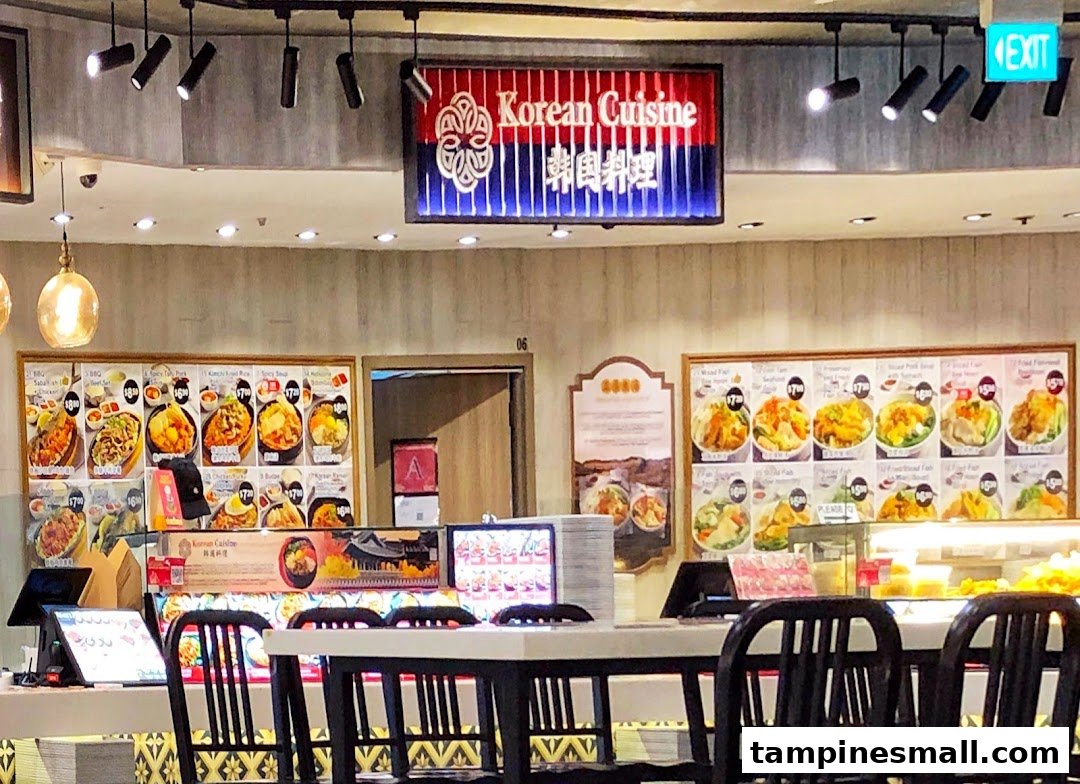 An interior view of a 'Korean Cuisine' food stall within a Kopitiam food court, featuring menu displays and dining area.