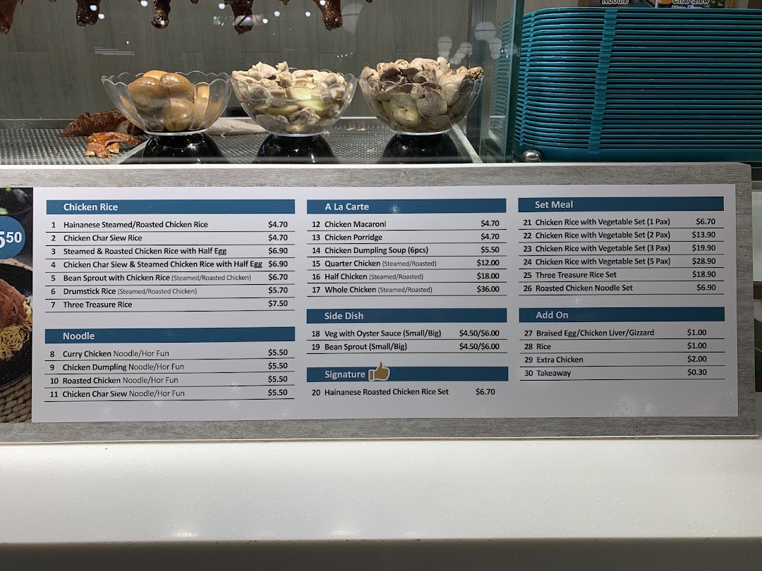 A detailed menu board displaying various chicken rice, noodle, and set meal options with prices.
