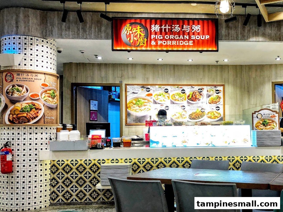 An interior view of Kopitiam, a food stall specializing in Pig Organ Soup & Porridge, with a counter and dining area.