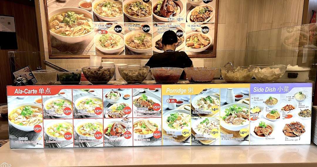 A vibrant menu board at Kopitiam showcasing a variety of traditional Singaporean dishes and side orders.