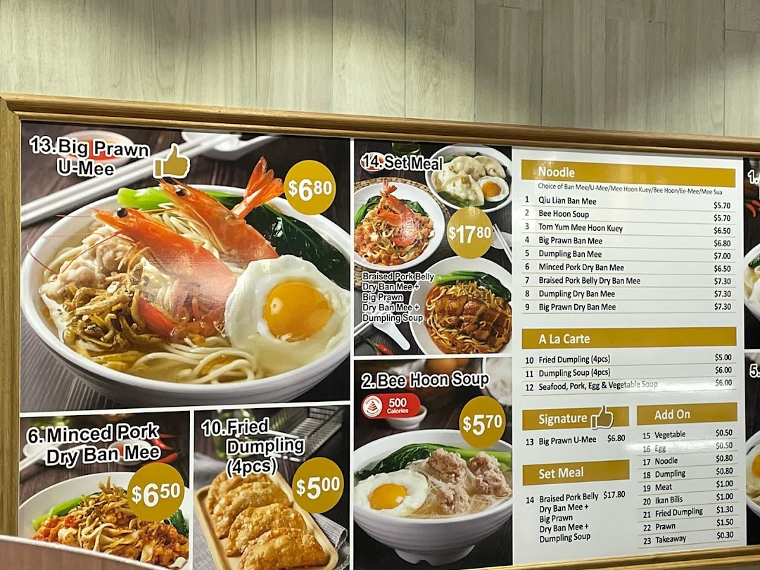 A detailed menu board displaying various noodle dishes, set meals, and add-ons with prices and images.
