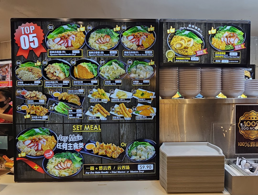 A large menu board showcasing various noodle dishes, sides, and a set meal offer at Kopitiam.