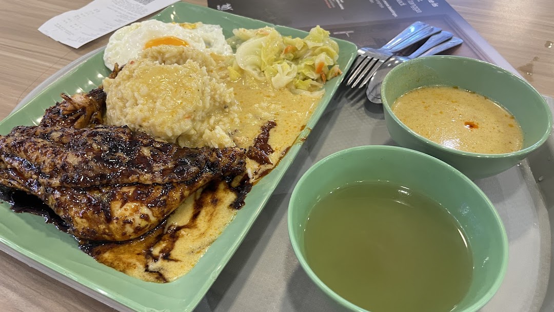 A delicious meal featuring glazed chicken, rice, fried egg, vegetables, and two accompanying soups.