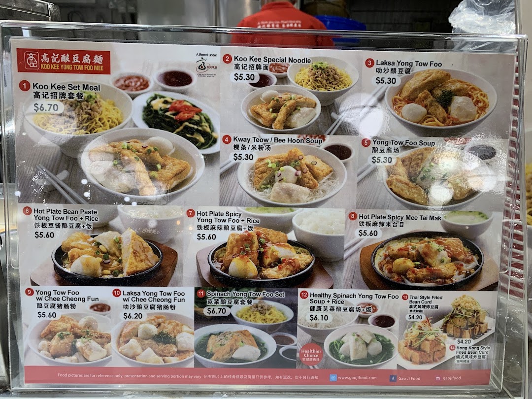 A detailed menu board for Koo Kee Yong Tow Foo Mee, showcasing various noodle, soup, and hot plate dishes with prices.