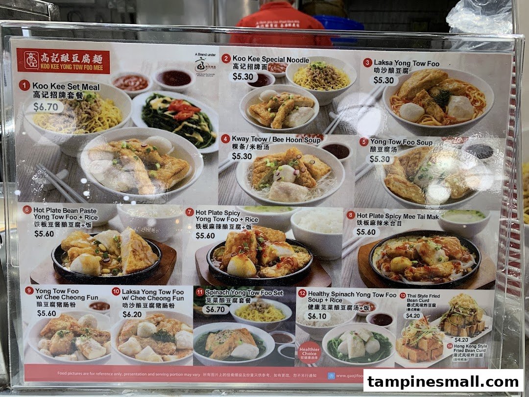 A detailed menu board for Koo Kee Yong Tow Foo Mee, showcasing various noodle, soup, and hot plate dishes with prices.