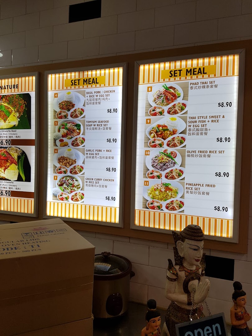 A brightly lit menu board displaying various Thai and Asian set meals with prices and images.