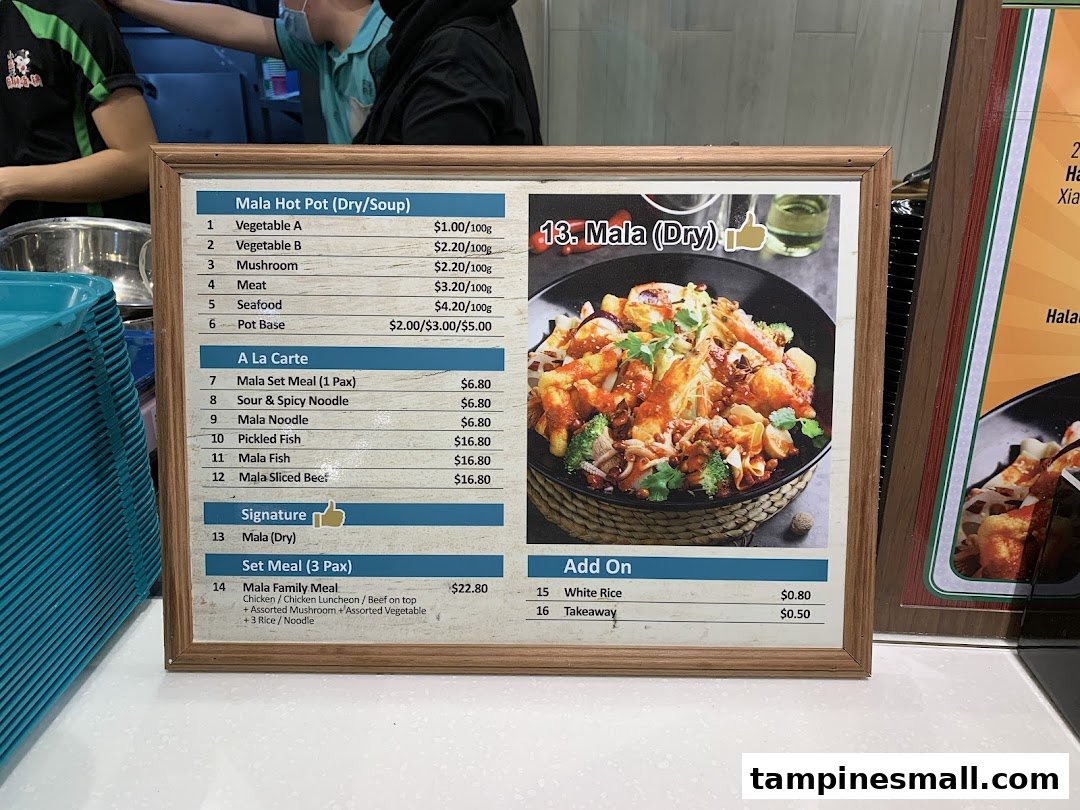 A framed menu board displaying various Mala hot pot and a la carte dishes with their prices and a featured image of Mala (Dry).
