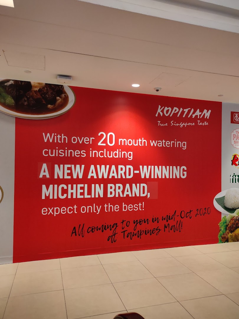 A large red promotional wall banner for Kopitiam, announcing new cuisines and a Michelin-awarded brand.