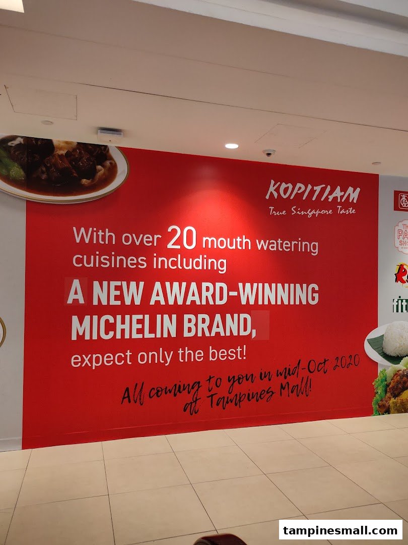 A large red promotional wall banner for Kopitiam, announcing new cuisines and a Michelin-awarded brand.