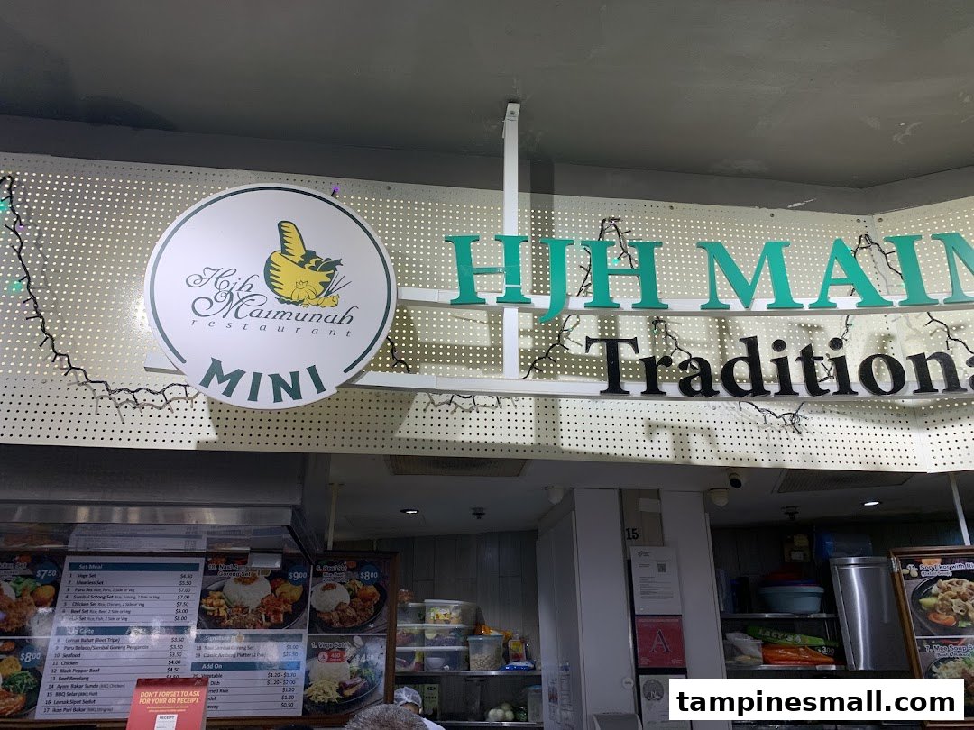 View of Hjh Maimunah Restaurant MINI signage and traditional food stall with visible menu boards.