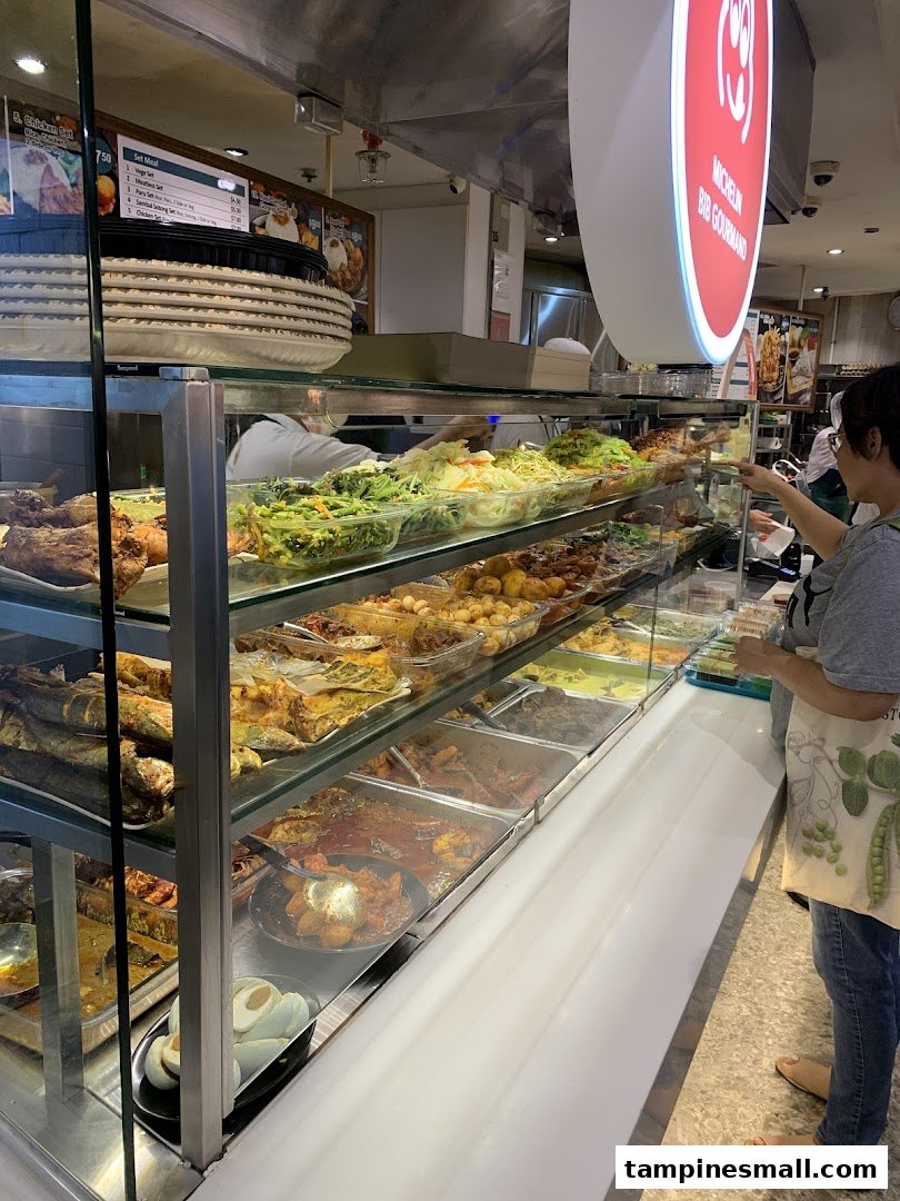 A bustling food stall showcasing a wide array of delicious Asian dishes in a display case.