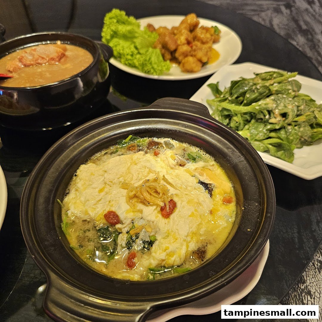 A table showcasing various delicious Chinese dishes, including a claypot, soup, fried chicken, and vegetables.