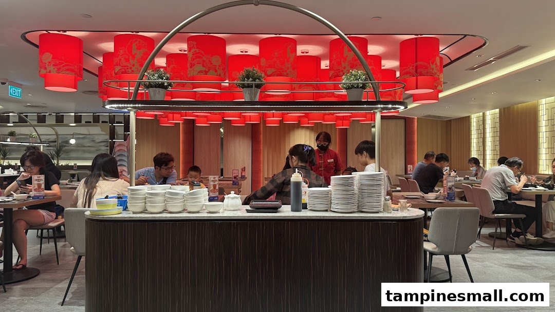A vibrant interior shot of Lao Huo Tang Signature, featuring diners enjoying meals under decorative red lanterns.