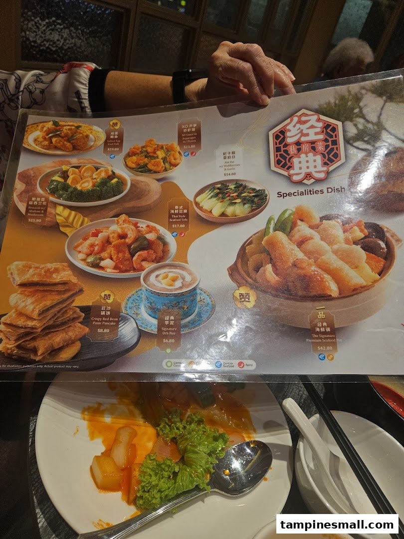A close-up of a restaurant menu featuring various Chinese specialty dishes and drinks.