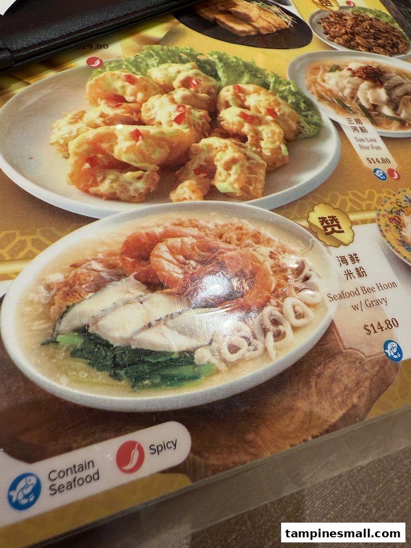 A close-up of a restaurant menu displaying various Chinese seafood and noodle dishes with prices.
