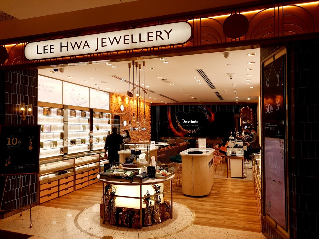 The brightly lit entrance of Lee Hwa Jewellery, showcasing its luxurious interior and sparkling display cases.
