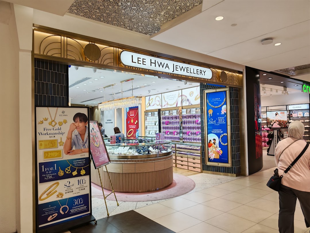 The image shows the elegant storefront and inviting interior of Lee Hwa Jewellery, featuring sparkling displays.
